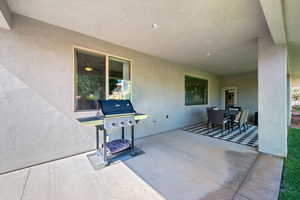 View of patio featuring area for grilling and outdoor dining space