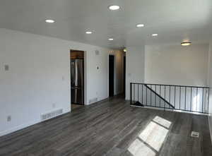Unfurnished room with recessed lighting and dark wood-style floors