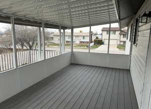 Unfurnished sunroom with a residential view