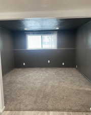 Spare room featuring a textured ceiling and light wood finished floors