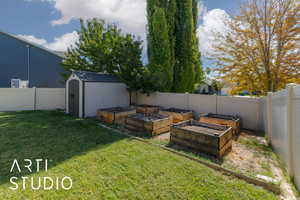 Fenced backyard with a shed and a garden