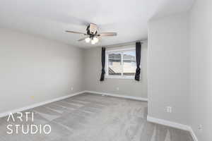Unfurnished room featuring light carpet and ceiling fan
