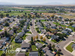 Aerial view of property's location with nearby suburban area and a mountainous background