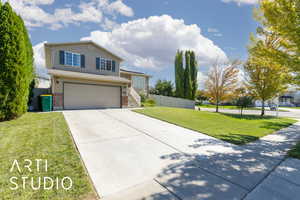 Traditional-style house featuring brick siding, driveway, and an attached garage