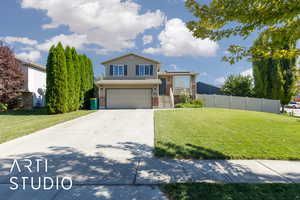 View of front of house featuring brick siding, driveway, and an attached garage
