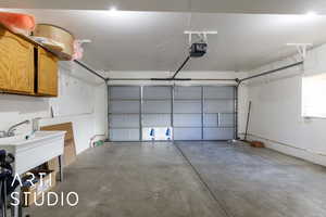Garage featuring a sink and a garage door opener