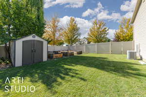 Fenced backyard with a vegetable garden and a storage shed