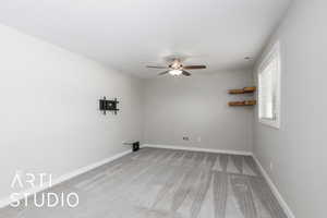 Unfurnished room featuring light carpet and a ceiling fan