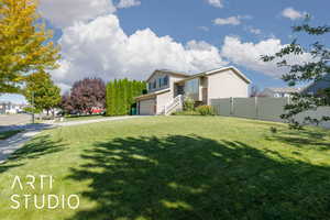 View of front of house with driveway and an attached garage