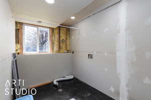 Laundry area with washer hookup and recessed lighting