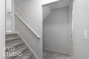 Stairway featuring carpet and baseboards