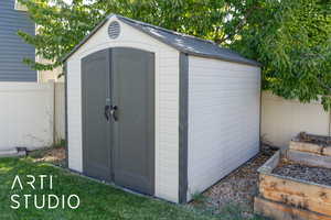 View of shed with a vegetable garden