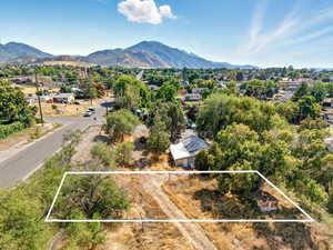 View of property location with a mountain backdrop and property boundaries highlighted
