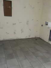 Laundry area with tile patterned floors and washer hookup