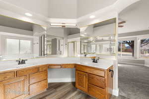 Bathroom with plenty of natural light, double vanity, wood finished floors, a stall shower, and recessed lighting