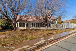 View of front of house featuring a tile roof and stucco siding
