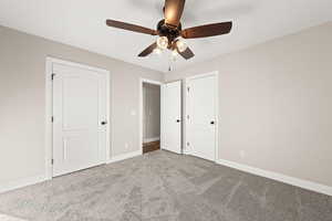 Unfurnished bedroom featuring carpet and a ceiling fan