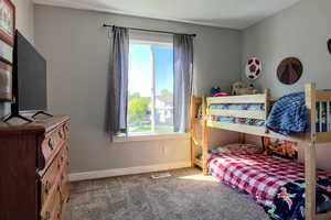 Bedroom with carpet flooring and baseboards