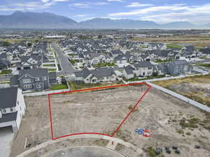 Aerial view of residential area featuring mountains and property boundaries highlighted