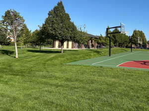 View of basketball court with a lawn, community basketball court, and a mountain view