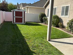 Fenced backyard with a storage shed