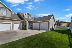 View of front of property featuring a shingled roof, a garage, and concrete driveway