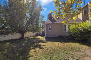 View of home's exterior with a chimney and roof with shingles