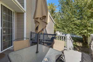 View of patio featuring outdoor dining space and a wooden deck