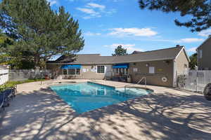 Community pool with a patio