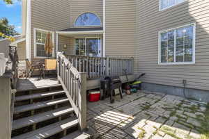View of patio featuring area for grilling and a wooden deck