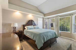 Carpeted bedroom featuring lofted ceiling and recessed lighting