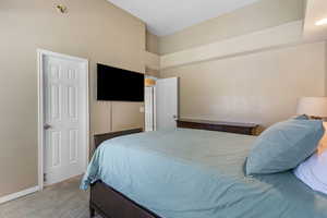 Bedroom with light carpet and baseboards