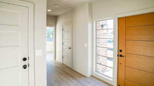 Doorway to outside featuring wood finished floors and recessed lighting