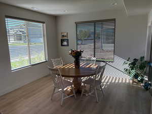Dining space with light wood-style floors and recessed lighting