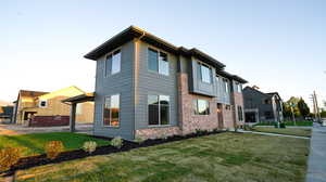 View of home's exterior with brick siding and a lawn