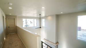 Corridor featuring recessed lighting, carpet floors, and an upstairs landing