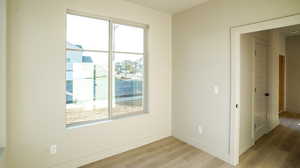 Unfurnished room featuring light wood-style floors and baseboards