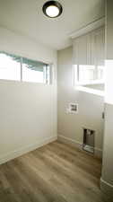 Laundry room with light wood-style flooring and hookup for a washing machine