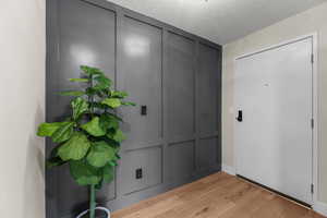 Foyer with paneled wall and Gabby light fixture