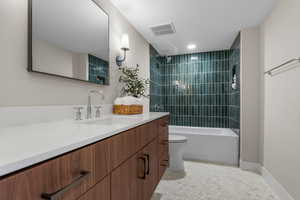 Bathroom with floating vanity, shower/bathtub combination, calcutta gold hex flooring
