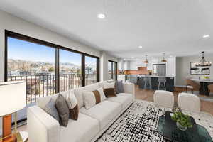 Living room with recessed lighting, real wood floors, and mountain views