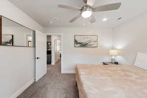 Bedroom featuring light colored carpet, a ceiling fan, and recessed lighting