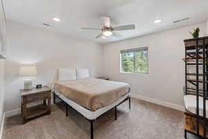 Bedroom featuring light carpet, a ceiling fan, and recessed lighting