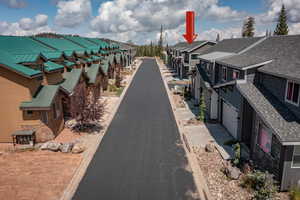 View of home's community with a garage, a residential view, and driveway