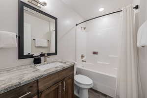 Bathroom with shower / bath combo, vanity, dark wood finished floors, and recessed lighting