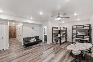 Bedroom featuring recessed lighting, wood finished floors, ceiling fan, and ensuite bathroom