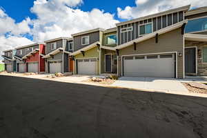 View of front of house featuring a residential view and concrete driveway