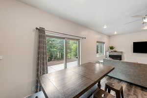 Dining room featuring a glass covered fireplace, recessed lighting, a ceiling fan, and wood finished floors