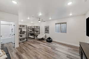 Rec room featuring ceiling fan, light wood-type flooring, and recessed lighting