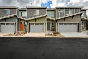 View of front of house featuring driveway and an attached garage